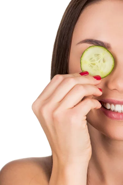 Woman with sliced cucumber for skincare mask — Stock Photo, Image