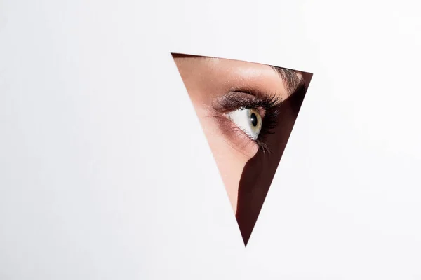 Woman looking out of hole — Stock Photo, Image