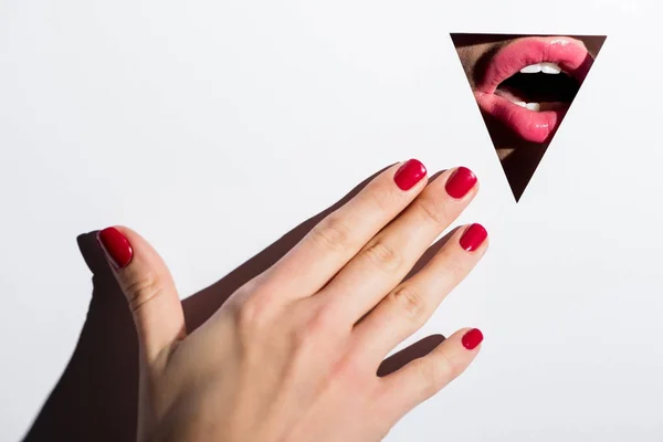 Woman lips behind triangle hole — Stock Photo, Image