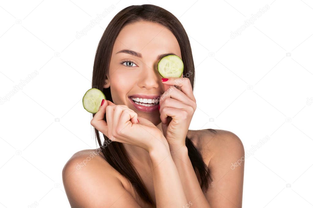 woman with sliced cucumber for skincare mask