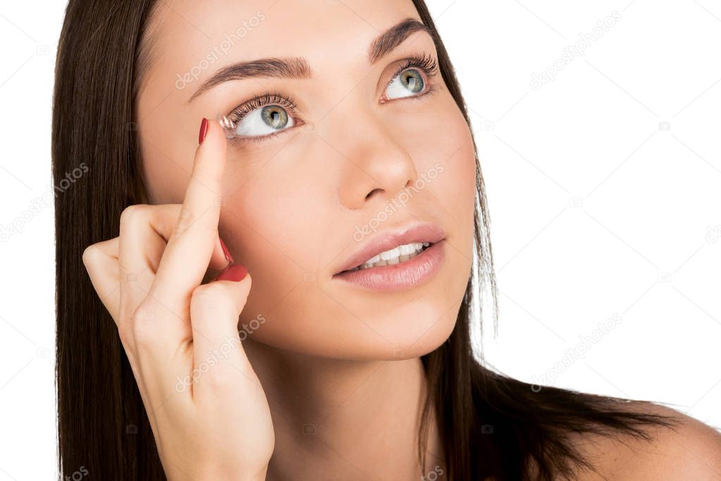 woman applying contact lens
