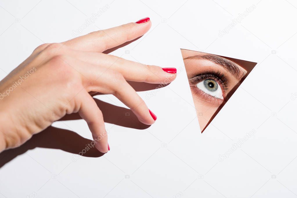 woman looking out of hole in paper