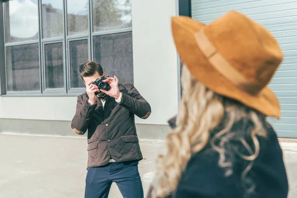 Man with camera photographing girlfriend — Free Stock Photo