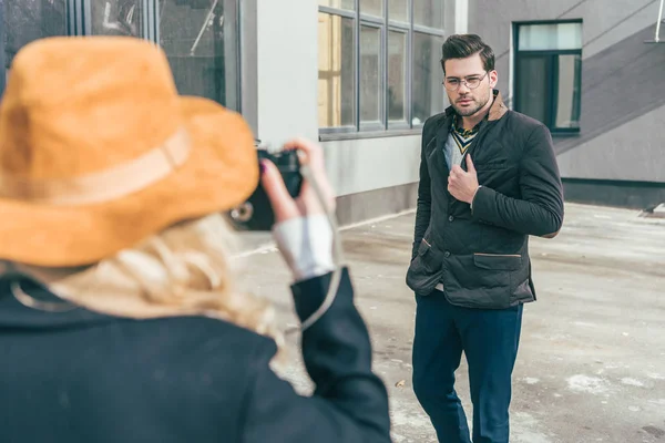 Woman with camera photographing boyfriend — Stock Photo, Image