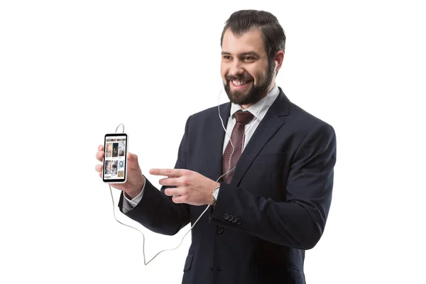 Businessman pointing at smartphone — Stock Photo, Image