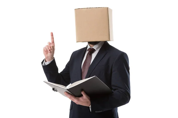 Businessman with box on head pointing up — Stock Photo, Image