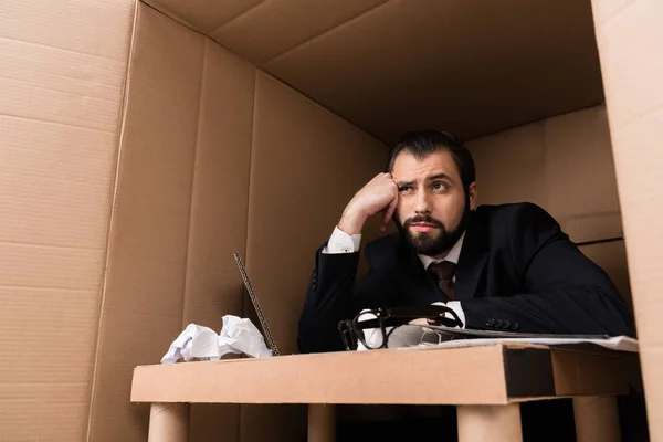 Bored businessman in box — Stock Photo, Image