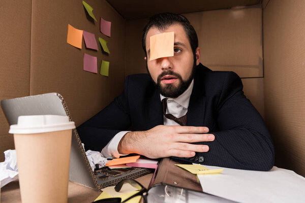 businessman with sticky note on forehead