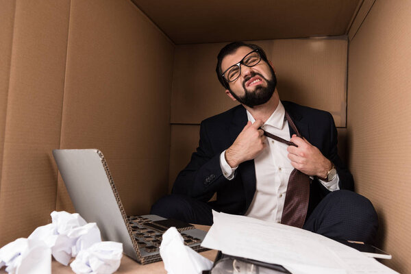 businessman removing tie