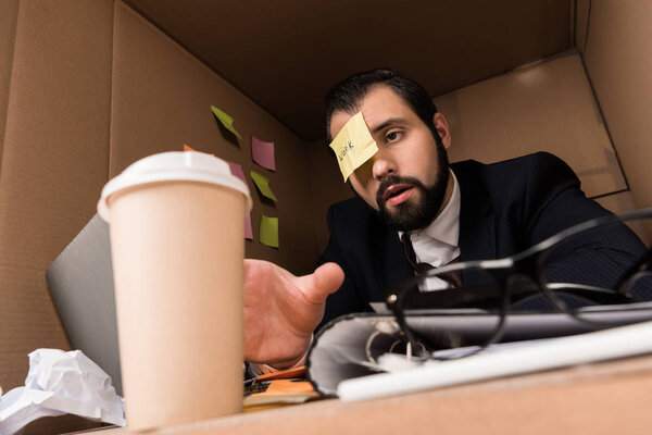 businessman with sticky note and coffee