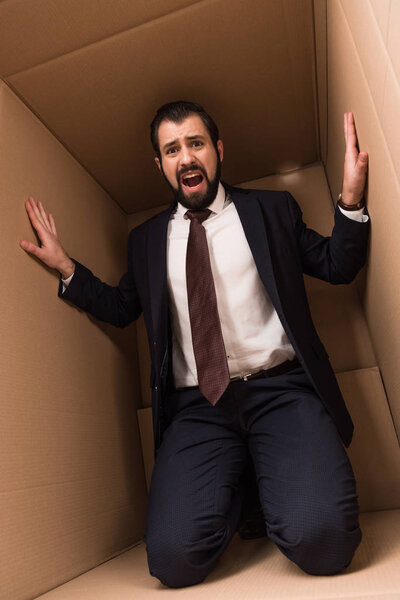 stressed businessman in box