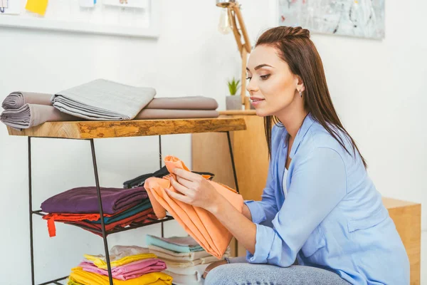 Smiling Beautiful Designer Holding Yellow Fabric — Free Stock Photo