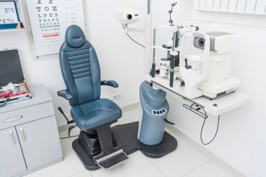 professional ophthalmic clinic with slit lamp  clipart