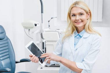 professional oculist using digital tablet in clinic clipart