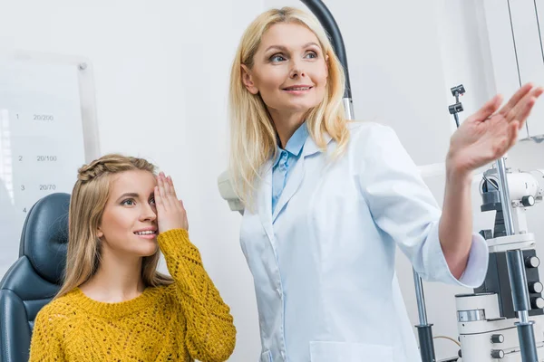 Oculist Gestikulerande Samtidigt Undersöka Vacker Patienten Klinik — Stockfoto