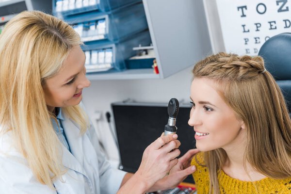 oculist examining beautiful patient in clinic