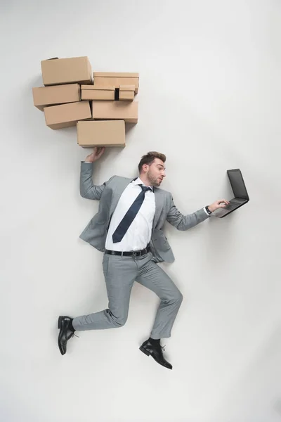 Overhead View Businessman Holding Cardboard Boxes Using Laptop Isolated Grey — Stock Photo, Image