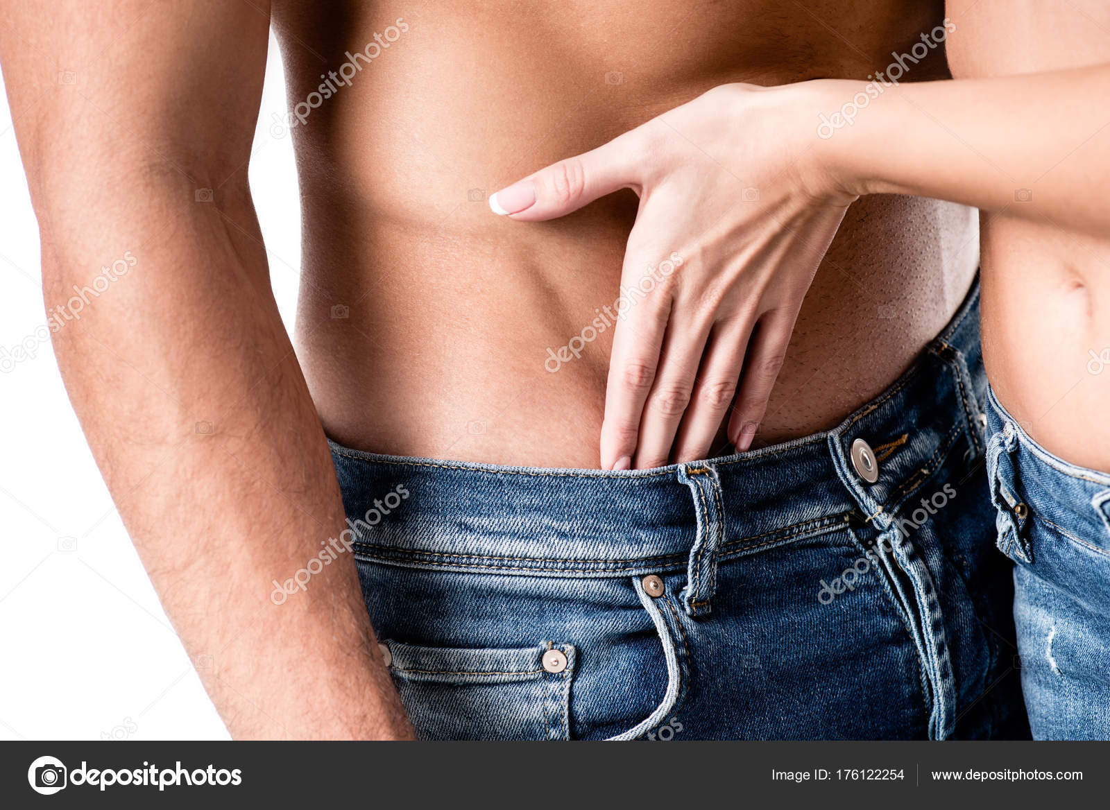 Woman's seductive hand on man's toned chest and abs intimate touch