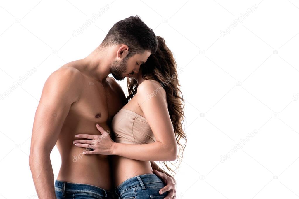 side view of acctractive sensual couple in jeans isolated on white
