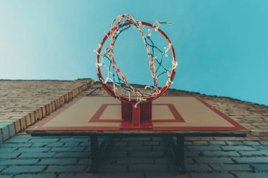 bottom view of basketball hoop on wall with graffiti  clipart