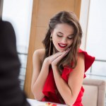 Partial view of man presenting gift to girlfriend in restaurant on st valentine day