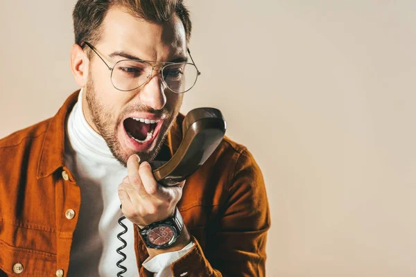 Portrait Stylish Man Screaming While Talking Telephone Isolated Beige — Free Stock Photo