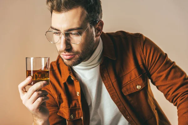 Portrait Thoughtful Fashionable Man Looking Glass Cognac Hand Isolated Beige — Stock Photo, Image