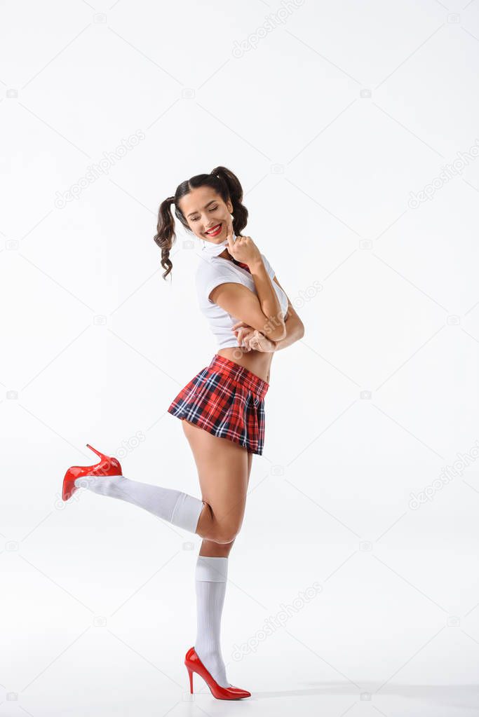 young attractive schoolgirl in short red skirt isolated on white