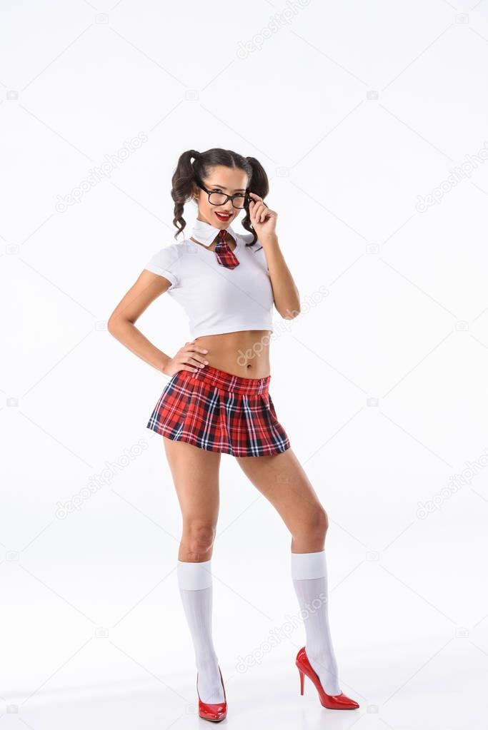 young sexy schoolgirl in red plaid skirt and eyeglasses isolated on white