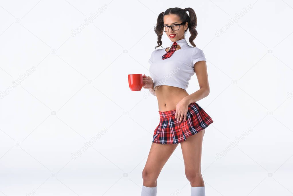 happy sexy schoolgirl with cup of coffee isolated on white
