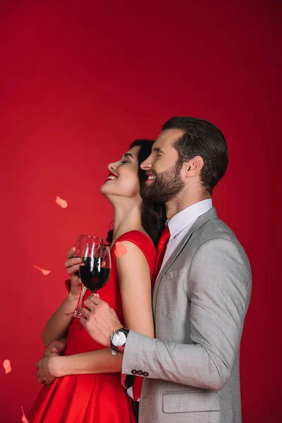 Side View Laughing Couple Wine Falling Confetti Isolated Red — Stock Photo, Image