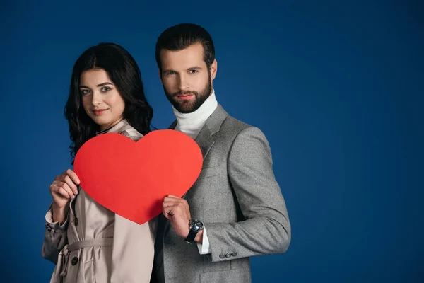 Couple Holding Heart Shaped Piece Paper Isolated Blue — Free Stock Photo