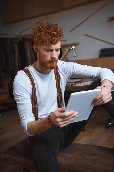 Serious Young Male Fashion Designer Using Digital Tablet — Free Stock Photo