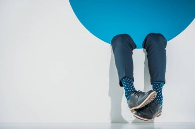 close-up partial view of stylish man falling into hole on grey clipart