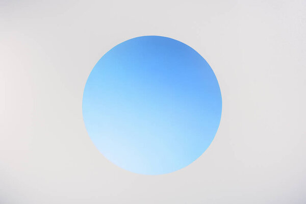 round blue hole with copy space on grey