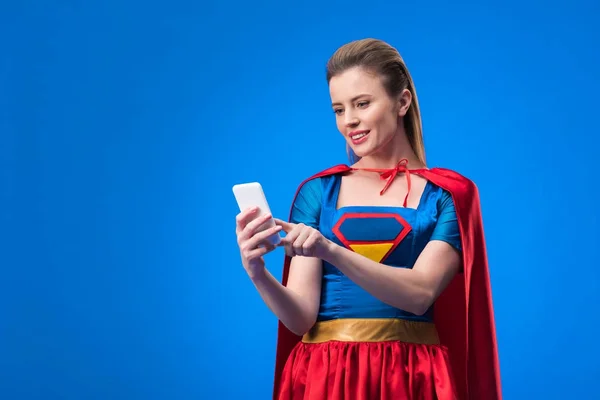 Portrait Smiling Woman Superhero Costume Using Smartphone Isolated Blue — Stock Photo, Image