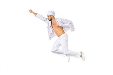 side view of young chef flying with raised hand isolated on white clipart