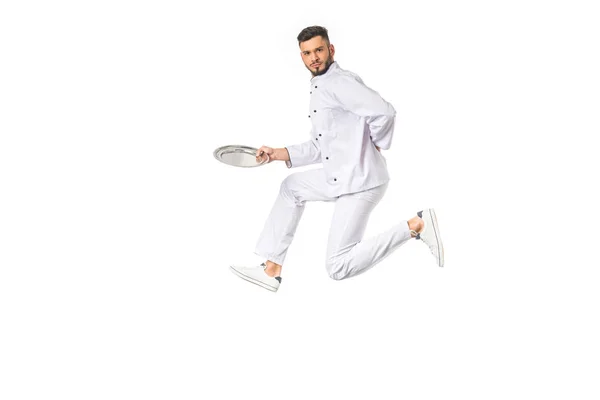 Young Male Chef Holding Plate While Jumping Looking Camera Isolated — Stock Photo, Image