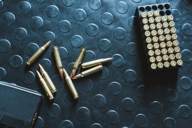 top view of rifle bullets and magazine on table clipart