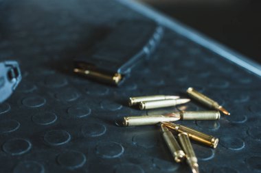 close up view of bullets and rifle magazine on table clipart