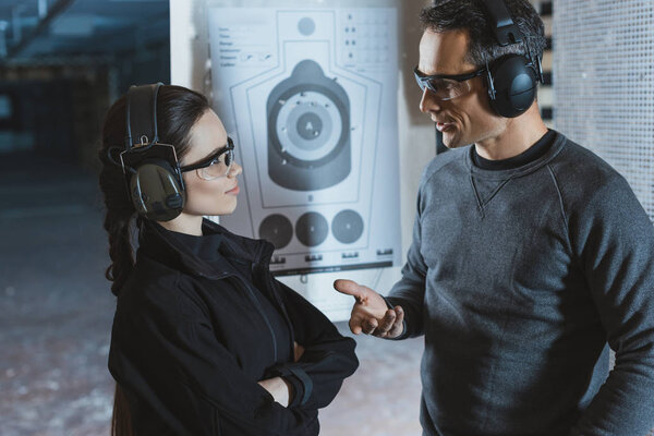 shooting instructor and client talking in shooting range