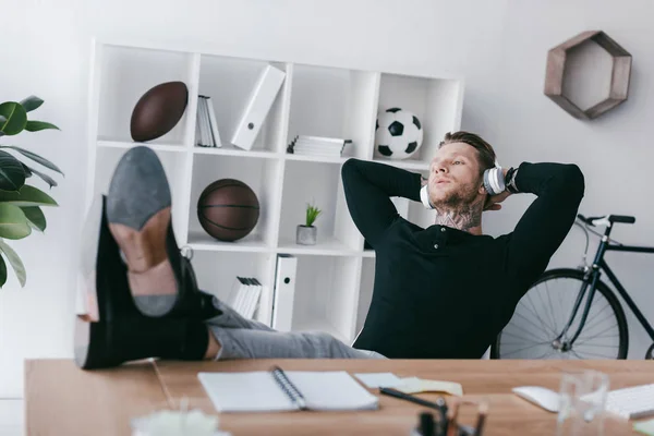 Handsome Young Tattooed Man Headphones Sitting Hands Head Office — Stock Photo, Image