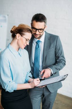 businessman pointing where to sign contract for colleague clipart