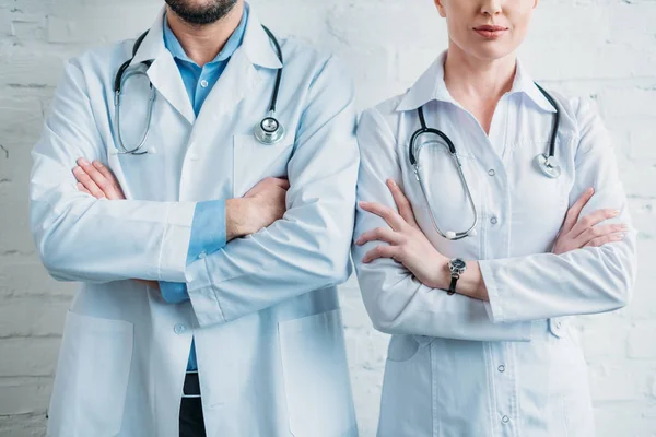 Tiro Recortado Médicos Com Braços Cruzados Frente Parede Tijolo Branco — Fotografia de Stock