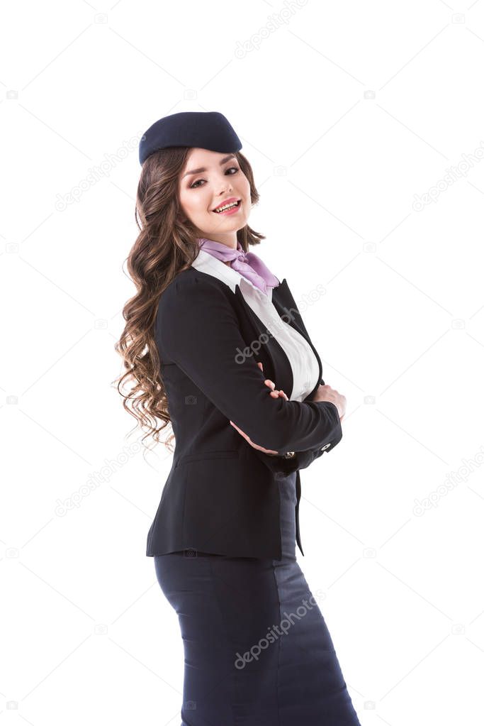 side view of attractive stewardess with crossed arms isolated on white