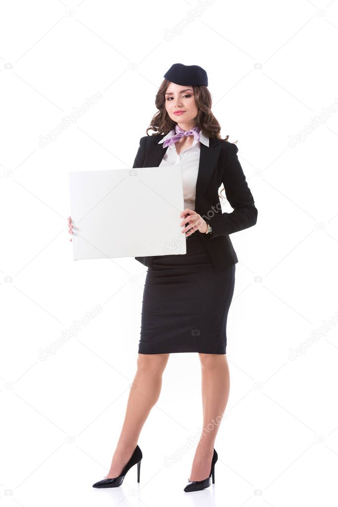 attractive stewardess holding empty board isolated on white