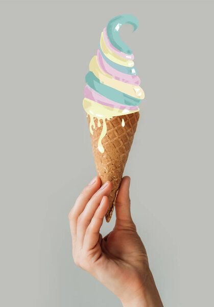 Cropped image of woman holding ice cream cone in her hand isolated on gray