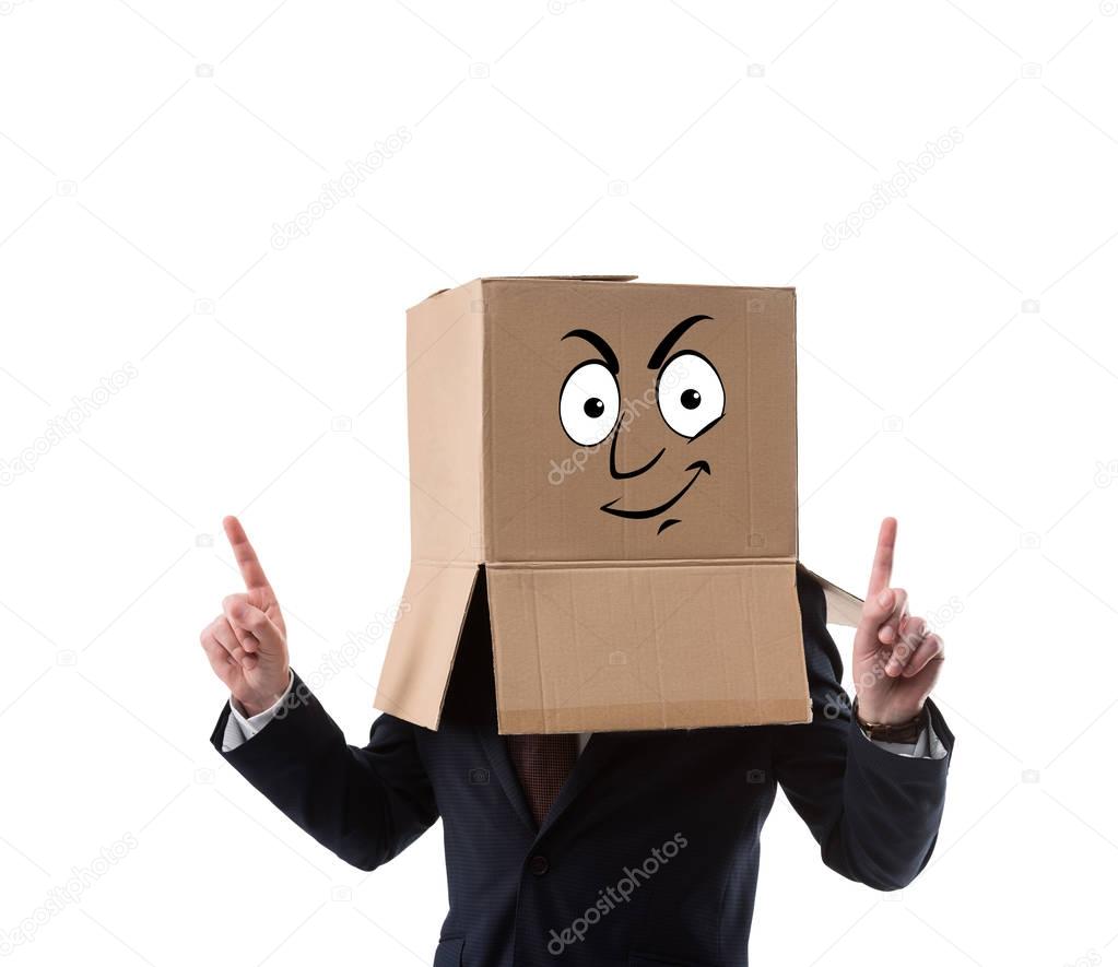 businessman with cardboard box on head pointing up with fingers  isolated on white