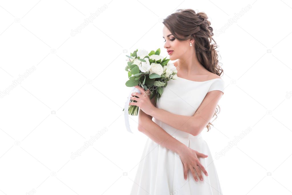 elegant bride posing in traditional white dress with wedding bouquet, isolated on white