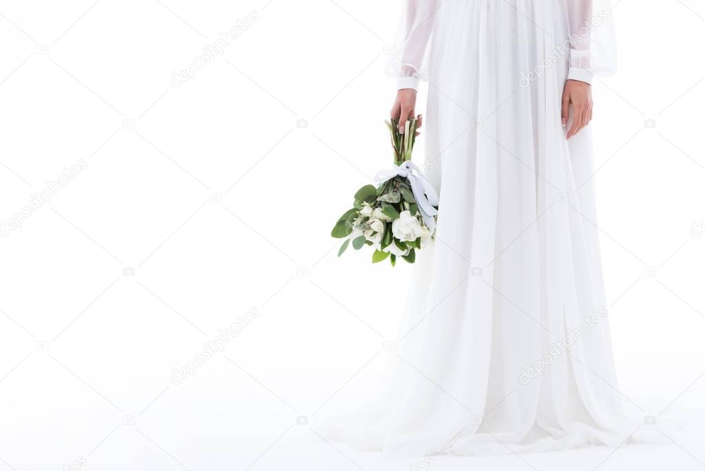 cropped view of bride in elegant dress with wedding bouquet, isolated on white
